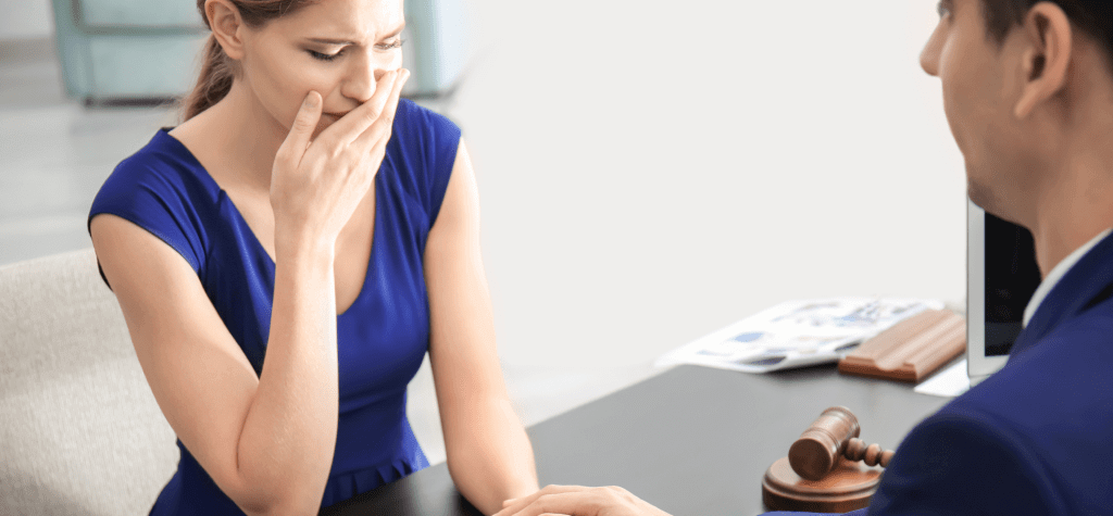 Woman cries while talking to an insurance agent