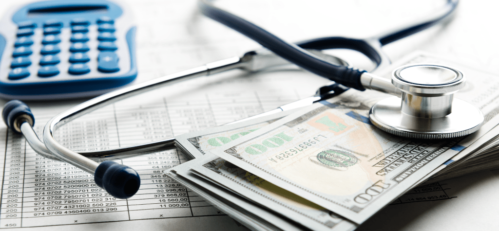 A stack of dollar bills sit on top of documentation