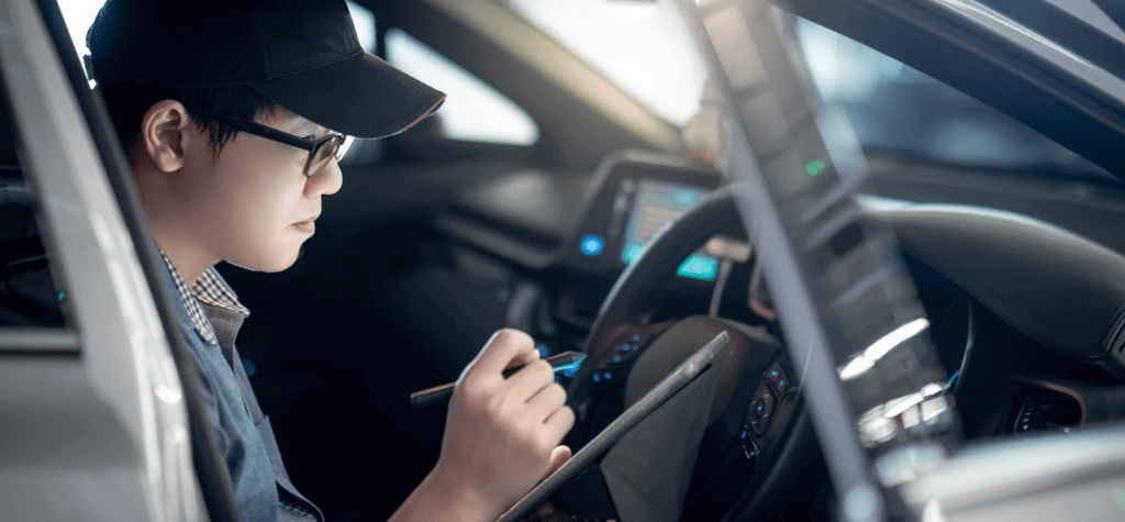 A car seat technician makes notes during an inspection