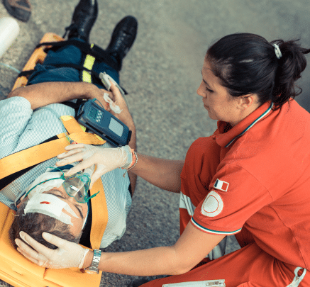 EMT woman helping man on stretcher get oxygen