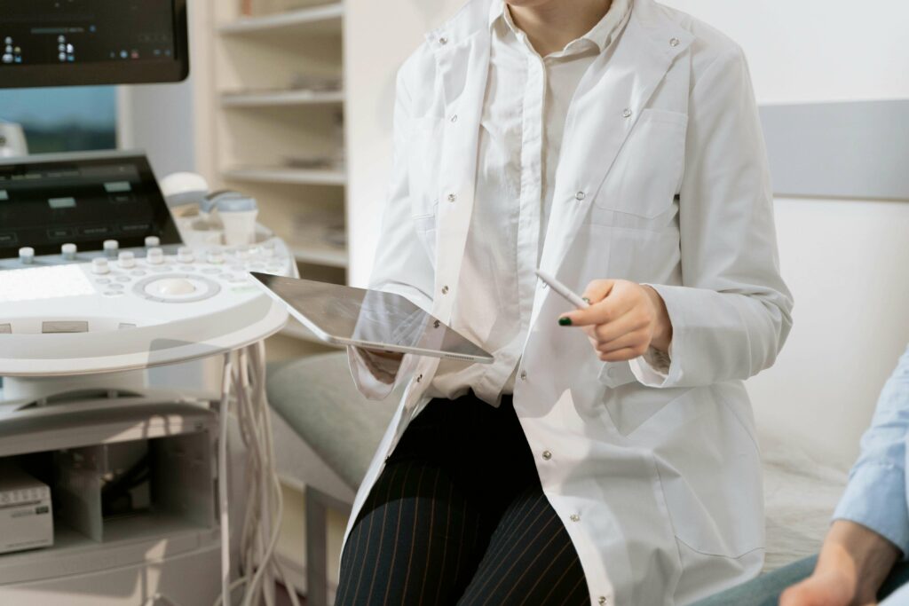 A close-up of a doctor with a tablet discussing diagnosis with patient