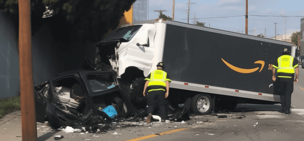 An Amazon semi truck ran into a building with emergency personnel around it 