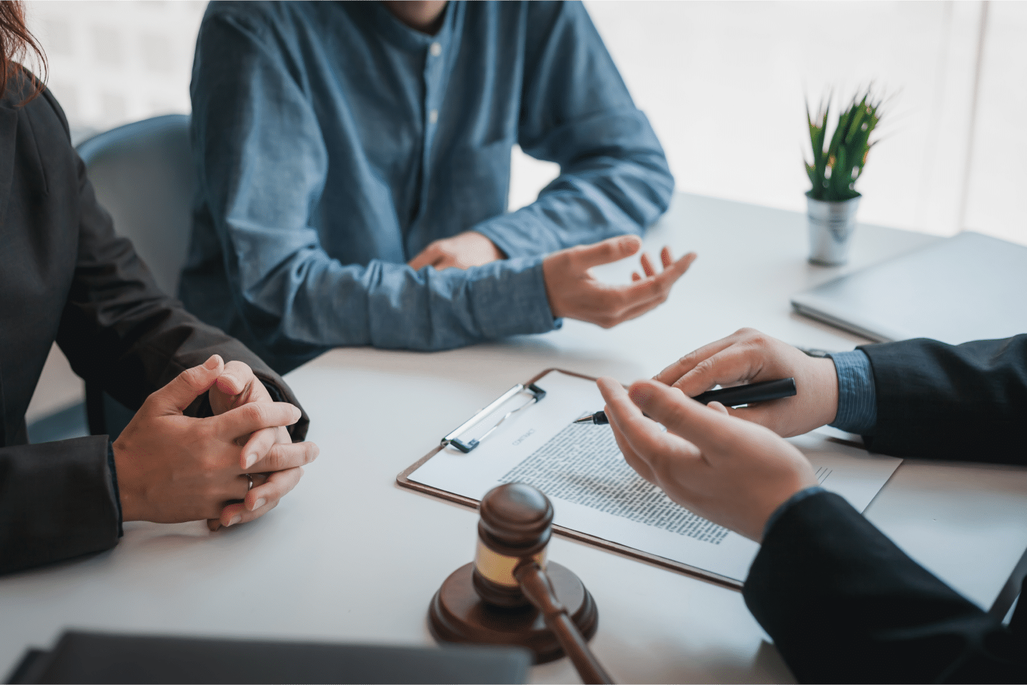 Men at table in meeting with gavel on table
