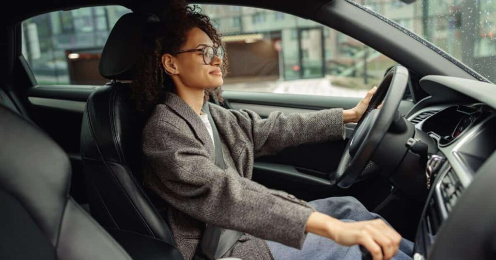 A woman drives in her car