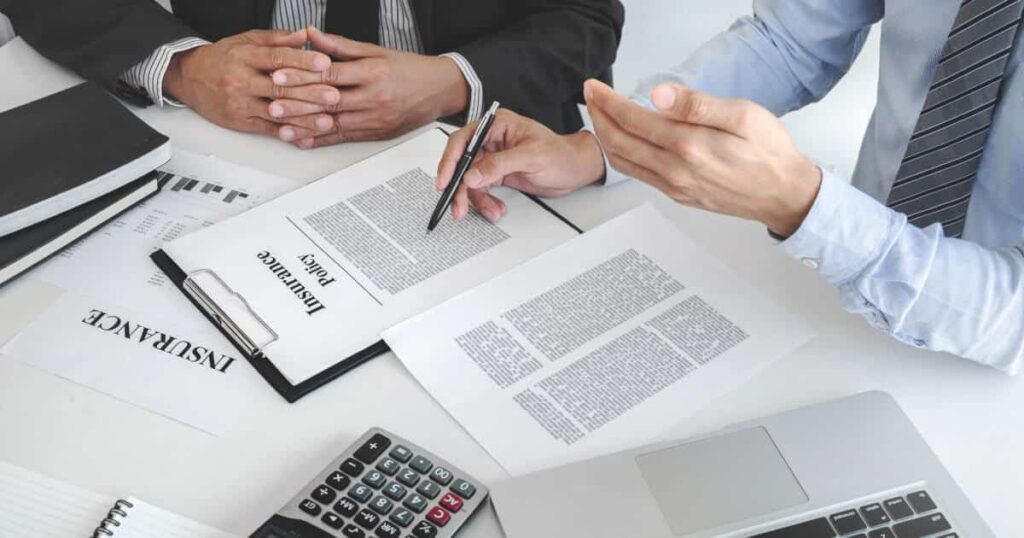 A close up of an insurance agent reviewing a policy line by line