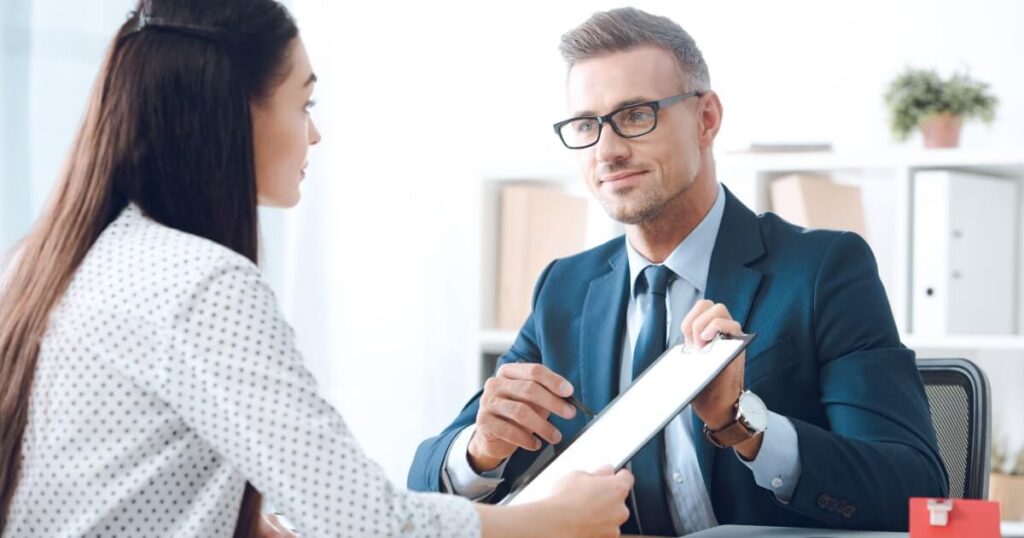 A insurance agent show his client their insurance policy