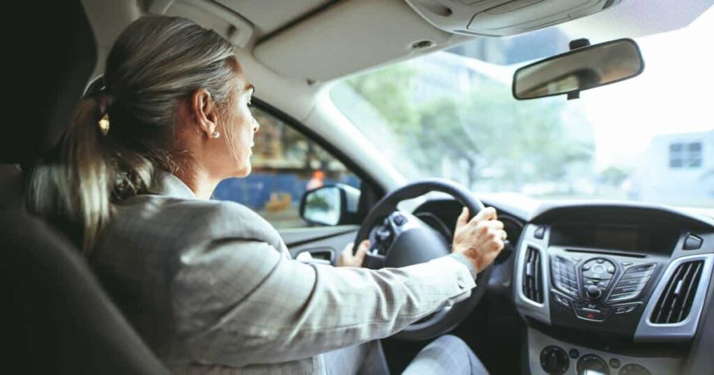 A woman drives safely in her car