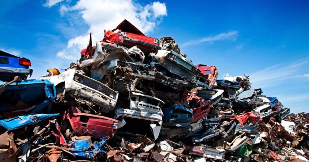 A pile of totaled cars at a junk yard