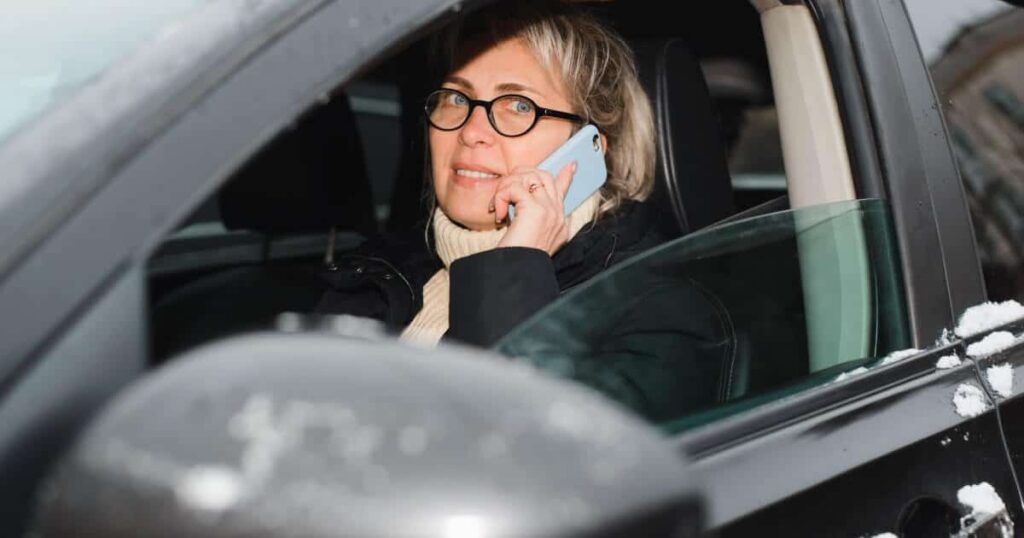A woman talks on the phone while driving