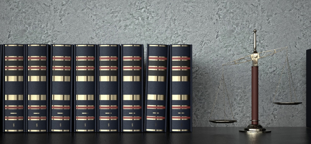 Legal books and scales of justice on a shelf
